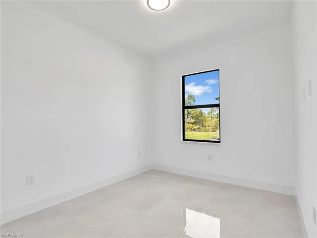 Unfurnished room featuring baseboards