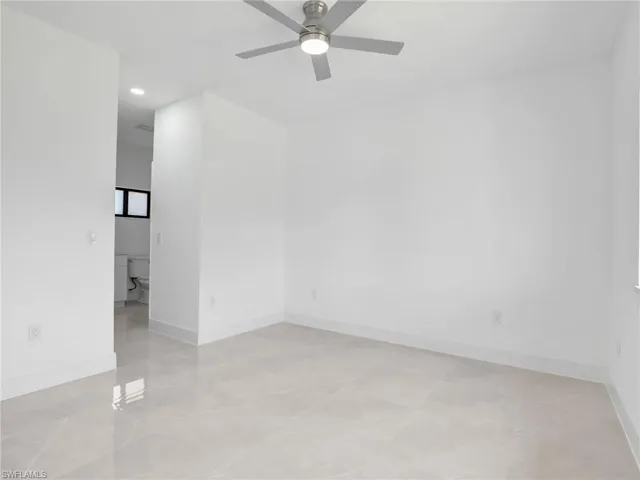Empty room featuring ceiling fan and recessed lighting