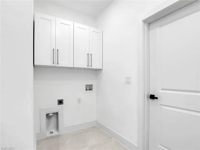 Laundry room with cabinet space, electric dryer hookup, and hookup for a washing machine