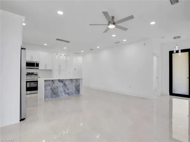 Unfurnished living room featuring recessed lighting and ceiling fan