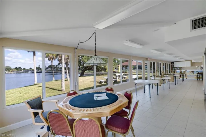 Dining space featuring light tile patterned floors and a water view