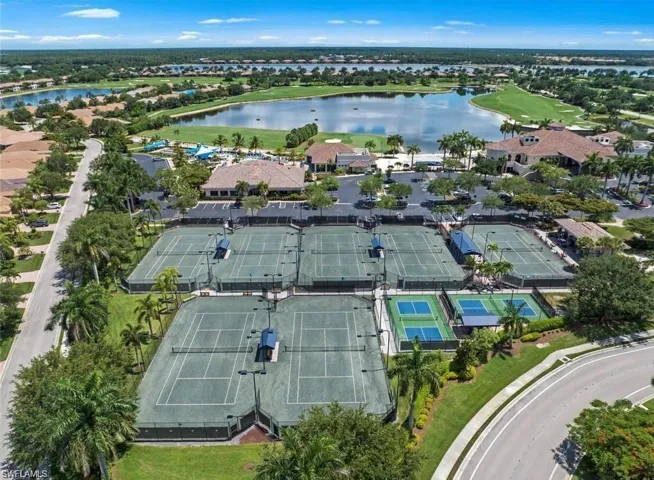 Birds eye view of property with a water view