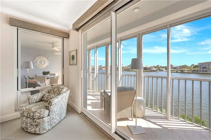 Sunroom / solarium featuring a water view