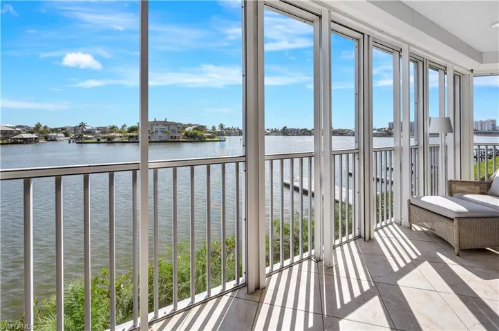 Unfurnished sunroom featuring a water view