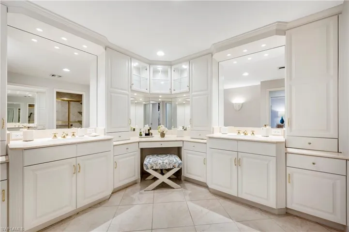 Bathroom with tile patterned flooring, vanity, and an enclosed shower
