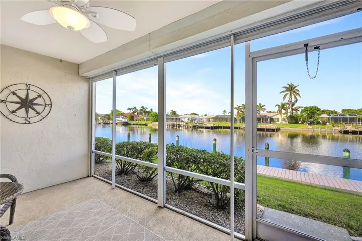 Sunroom featuring a water view and ceiling fan
