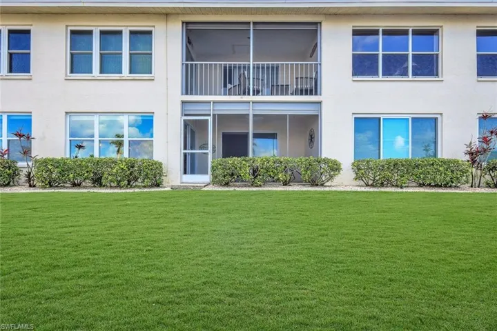 Back of house with a lawn