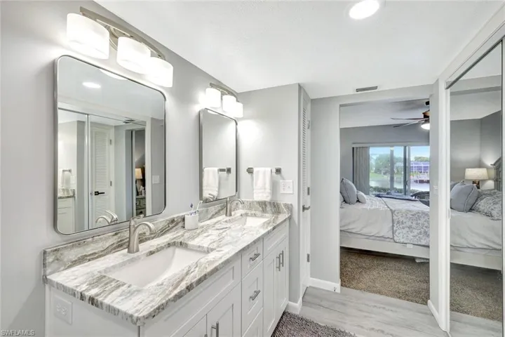 Bathroom featuring vanity, hardwood / wood-style flooring, and ceiling fan