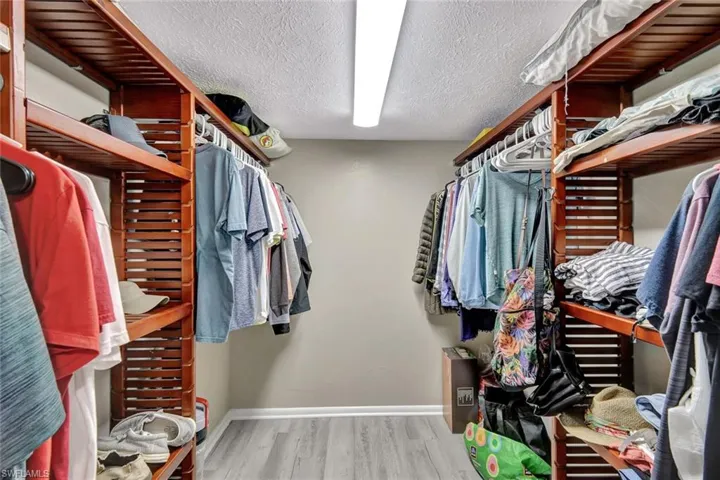 Spacious closet with light hardwood / wood-style flooring