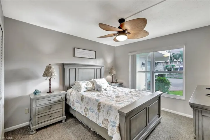 Carpeted bedroom with ceiling fan