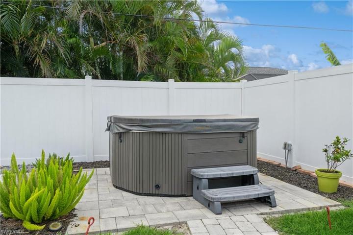 Hot tub and fenced backyard