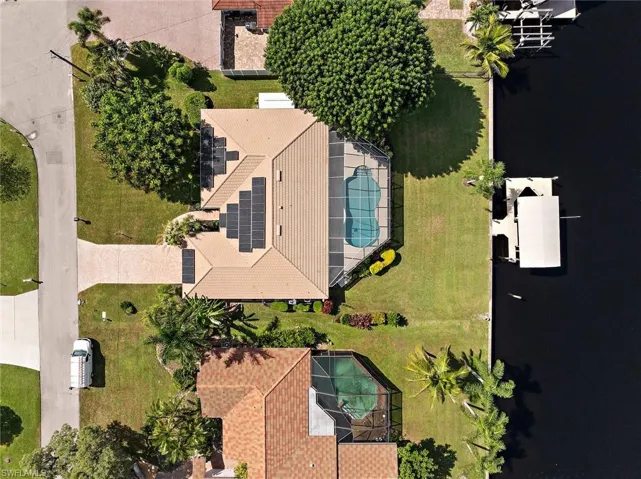 Aerial view of property and surrounding area featuring a pool