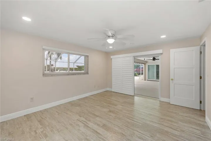 Unfurnished bedroom featuring recessed lighting, light wood-style flooring, multiple windows, and a ceiling fan