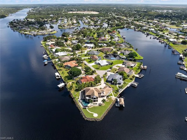 Aerial view of property and surrounding area with a nearby body of water