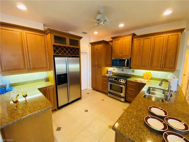 View of Efficient Kitchen with Crown Trim Cabinets, Under Counter Lighting, Granite Counters, Recessed  Ceiling iLighting and Stainless Package