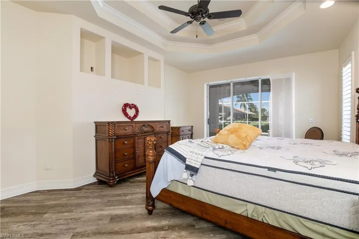 View of Coffered Master-1 Suite with Coffered Ceiling and Slider to Lanai Under Truss