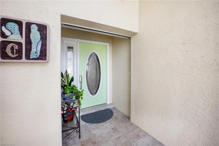Entrance to property featuring stucco siding