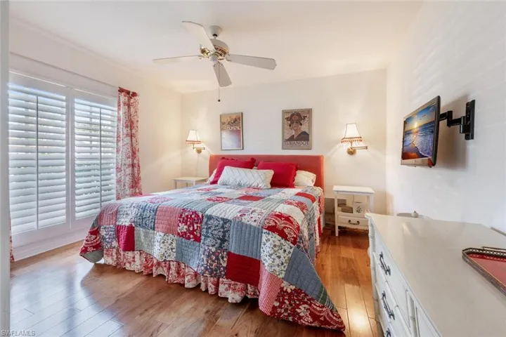 Bedroom with ceiling fan and light wood-type flooring