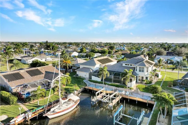 Aerial view of residential area featuring a large body of water