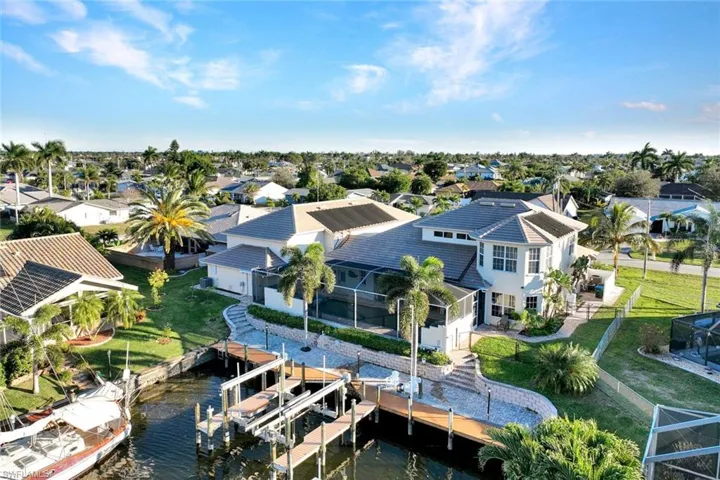 Aerial perspective of suburban area featuring a nearby body of water