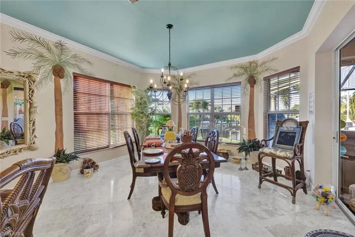 Dining space featuring ornamental molding and a chandelier