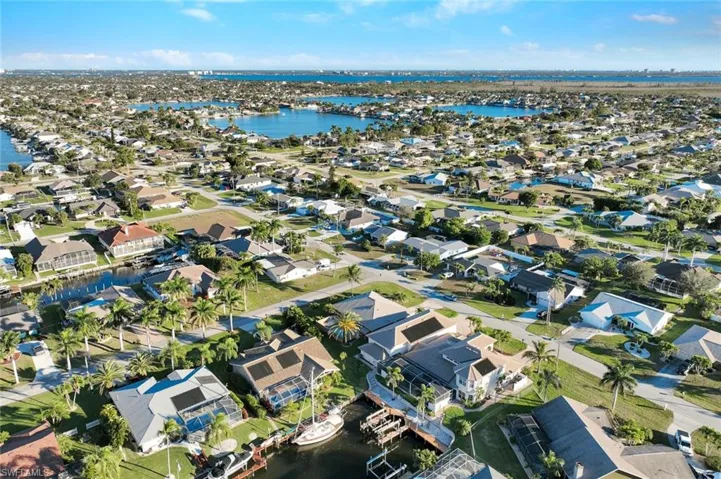 View of property location featuring a nearby body of water and nearby suburban area