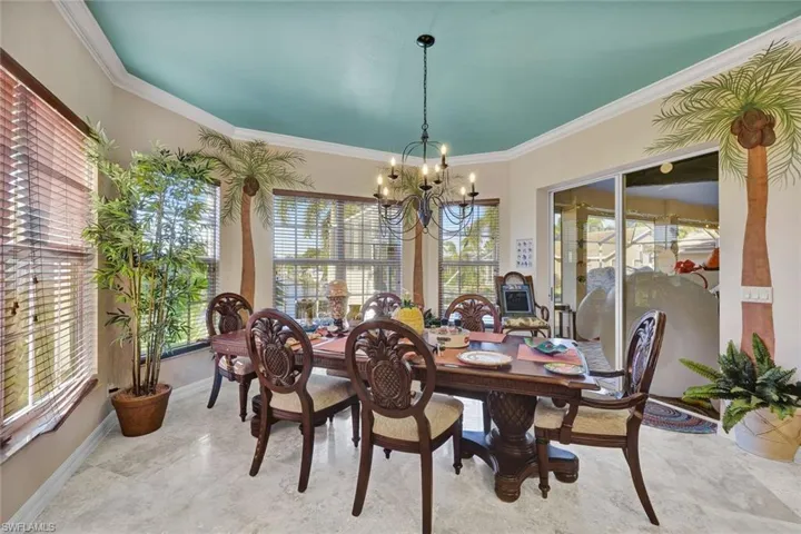 Dining space with a chandelier and ornamental molding