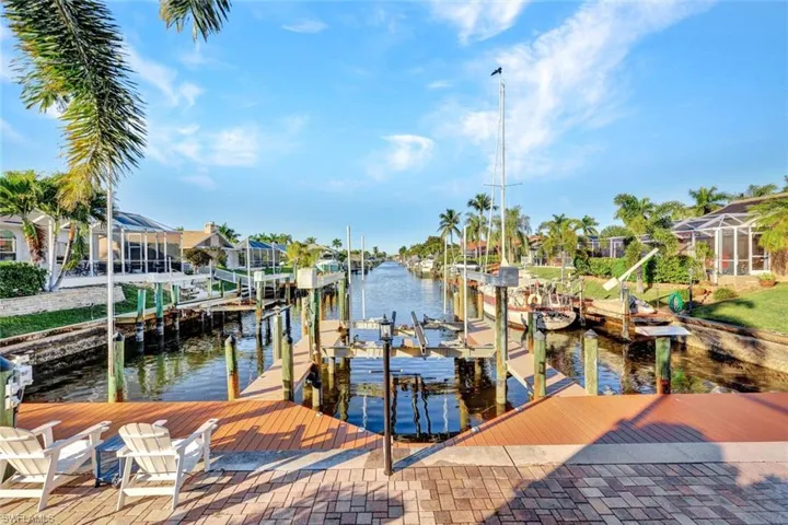 Dock featuring boat lift and a water view
