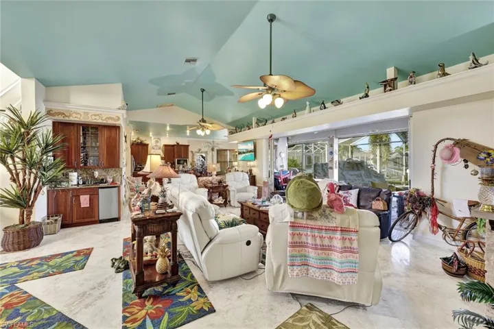 Living area featuring vaulted ceiling and ceiling fan