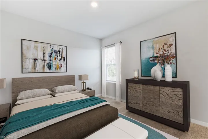This image is virtually staged. Bedroom featuring light carpet and baseboards