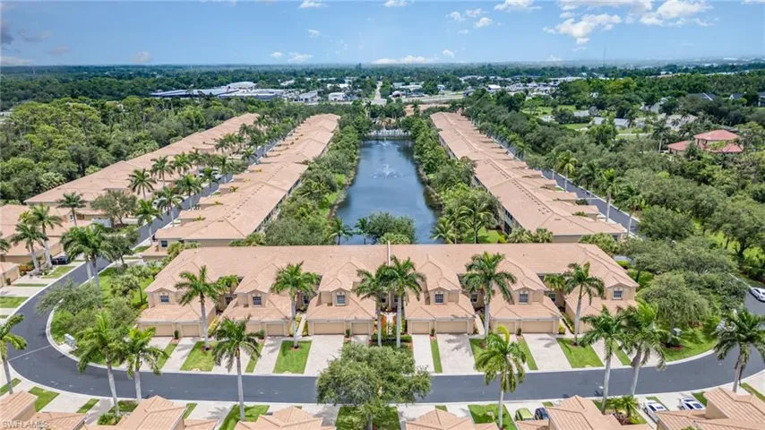 Aerial perspective of suburban area featuring a large body of water
