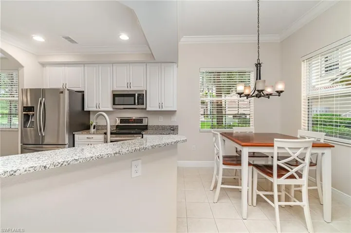 Kitchen featuring stainless steel appliances, white cabinetry, crown molding, and recessed lighting
