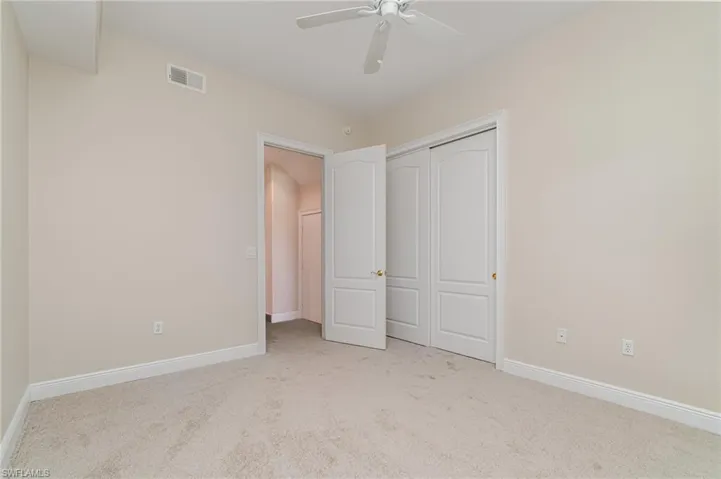 Laundry room featuring cabinet space, light tile patterned floors, electric panel, and independent washer and dryer