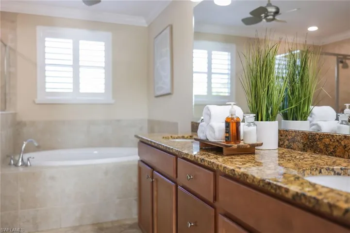 Primary ensuite with soaking tub, walk in shower, separate water closet and storage closet