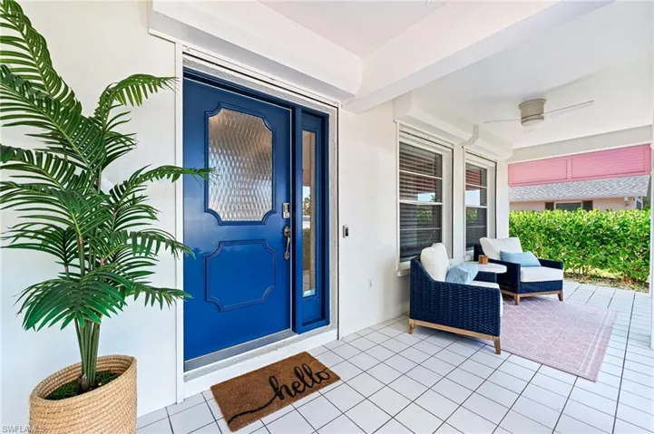 Property entrance with stucco siding and a patio