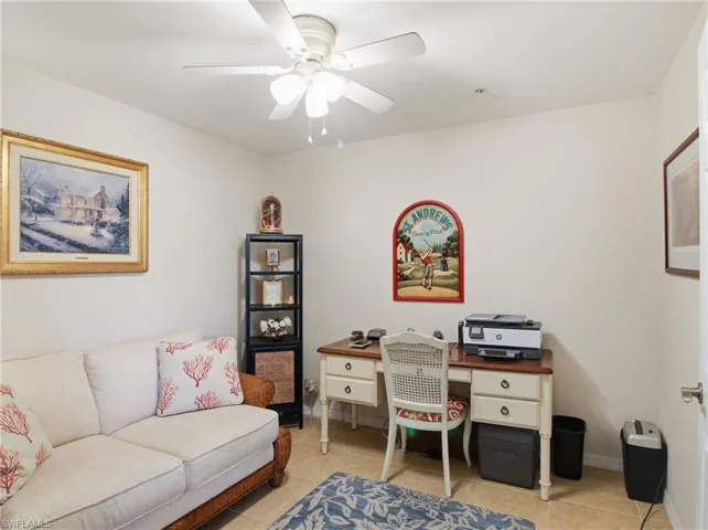 Office area with ceiling fan and light tile patterned floors