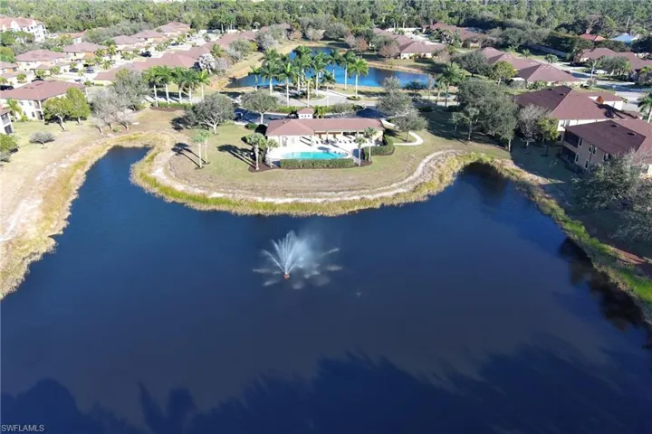 Aerial view of property and surrounding area featuring a large body of water and nearby suburban area