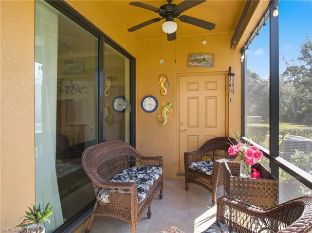 Sunroom featuring a ceiling fan