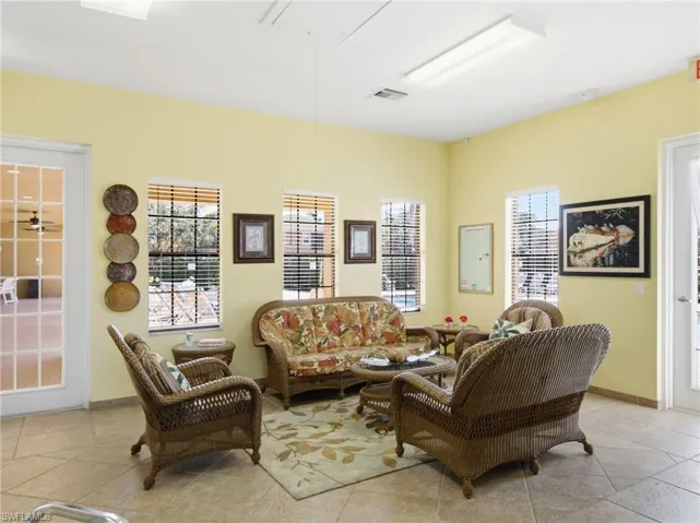 Living area with baseboards and attic access