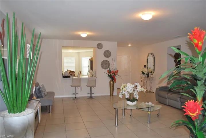 Tiled living area featuring baseboards