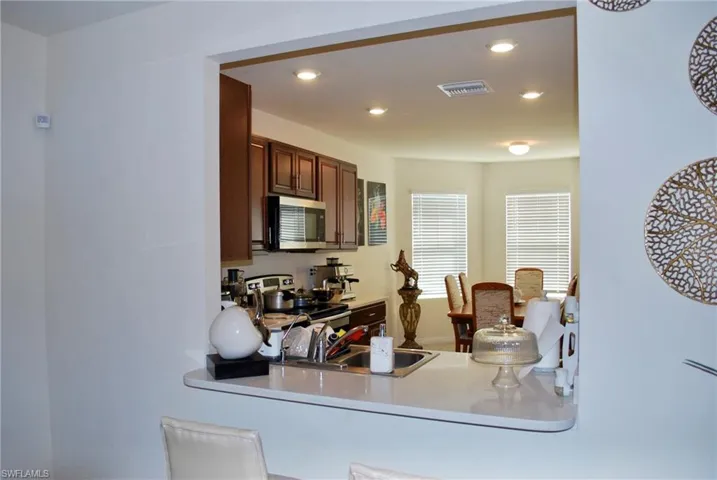 Kitchen featuring stainless steel appliances, recessed lighting, light countertops, and a peninsula