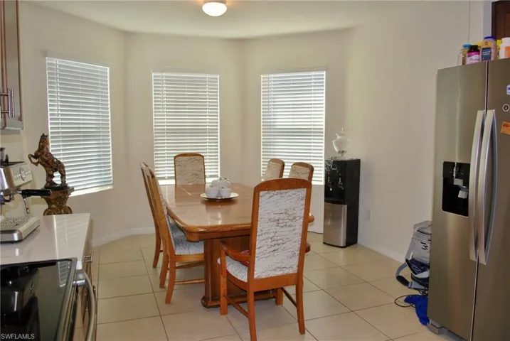 Dining space featuring light tile patterned floors