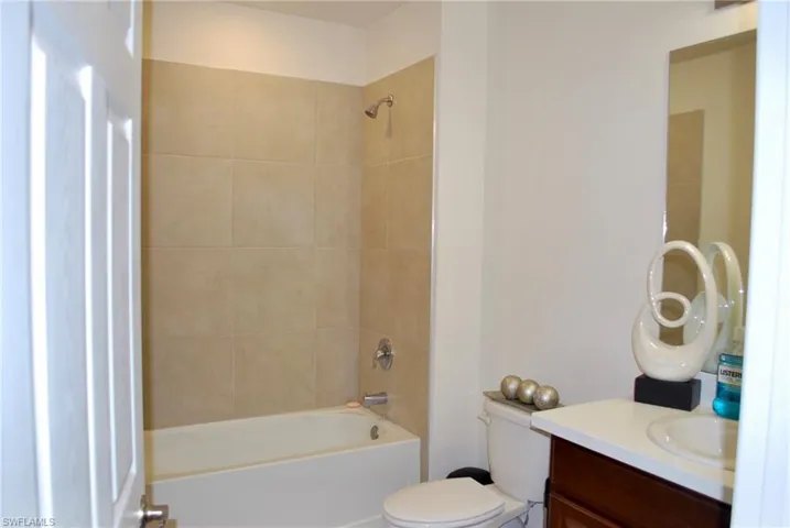 Bathroom with vanity and washtub / shower combination