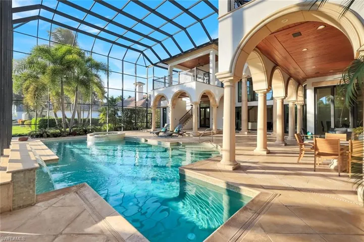 View of pool with a balcony, a patio area, a lanai, and a pool with connected jacuzzi