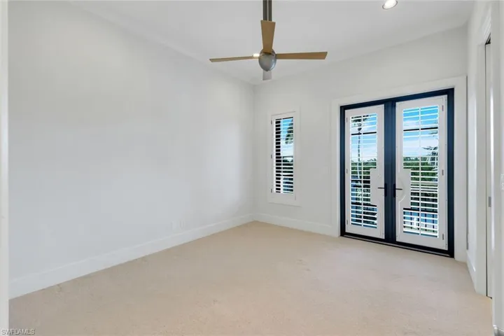 Unfurnished room featuring light carpet, a ceiling fan, french doors, and recessed lighting