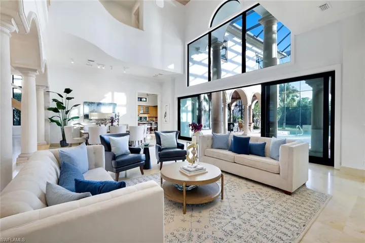 Living area with a high ceiling and ornate columns