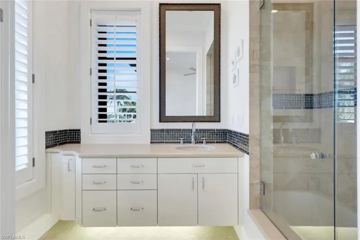 Bathroom featuring vanity and plenty of natural light