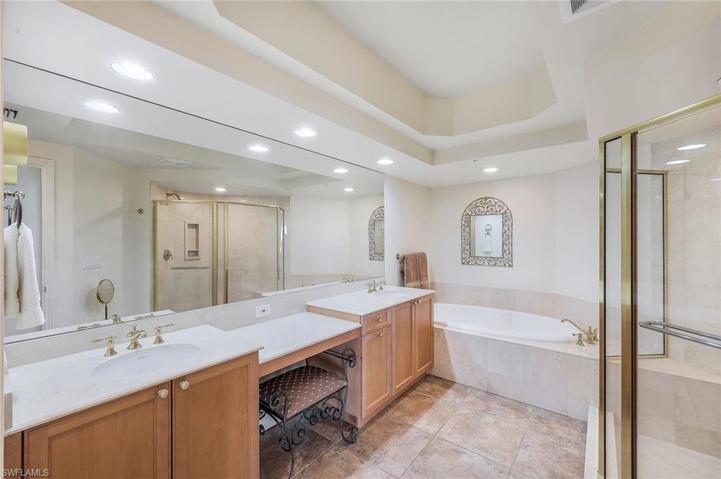There is plenty of room for TWO in this primary en-suite bathroom. Walk in shower, soaking tub, two separate sink/counter areas, a vanity area and ample closet space accessible between bed and bath.