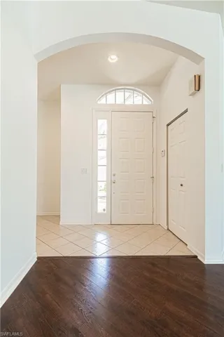 Recently painted white -Kitchen featuring appliances with stainless steel finishes, white cabinets, sink, ceiling fan with notable chandelier, and ornamental molding