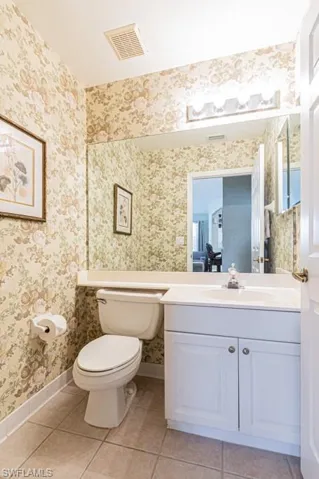 Recently painted white - Master Bathroom with tile patterned floors, separate shower and tub, crown molding, and dual bowl vanity